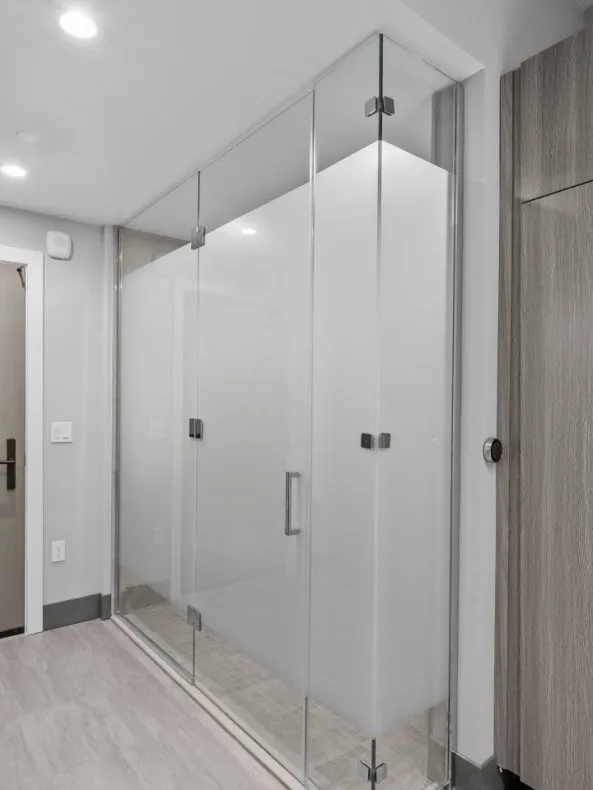 European style wet bathroom with floor to ceiling tile and glass shower wall at Salt Lake Crossing.