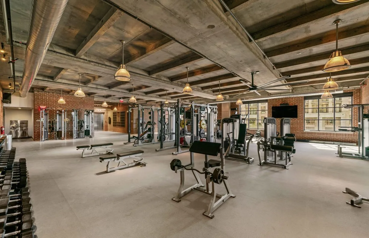 Fitness center at Salt Lake Crossing with weight equipment and large windows.