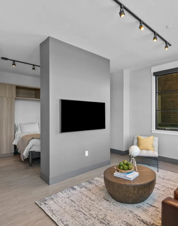 Open one-bedroom apartment with TV and seating area at Salt Lake Crossing.